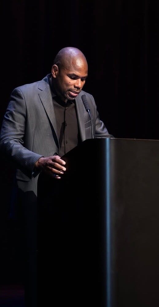 Henry Crockett speaking at a podium